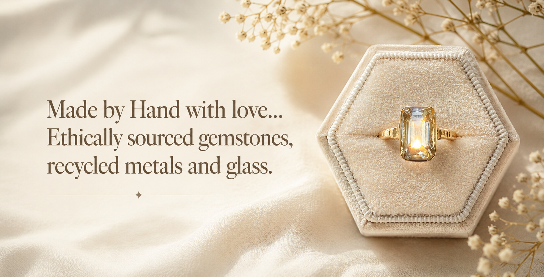 Handcrafted gold ring featuring a deep blue gemstone on a natural stone display by Marilea Jewelry.